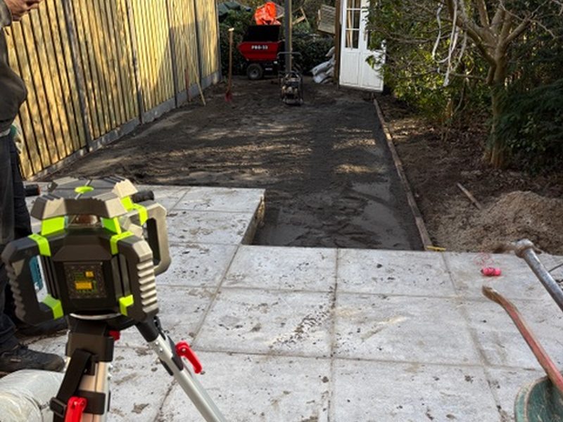 Tegels uitzetten met een laser in een smalle tuin
